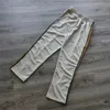 Męskie spodnie mężczyźni kobiety 1: 1 w paski haftowe igły motylki ścieżki Awge Spodnie szare zielone taśma