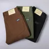 Automne Mens Slim Stretch Jeans à la mode et polyvalent en tissu doux pantalon armée armée Coffee Green Brand masculin Brand de marque 240321