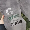 Nowa wiosenna i jesień Koreańska luksusowa odzież Polerowana jeansowa motocykl gorący motocykl szary szczupły haft kowboj