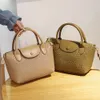 Designer handväskor för kvinnor små väska kvinnor ny trendig mångsidig crossbody mode en axel handväska hink