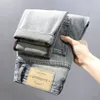 Mäns jeans koreanska versi trendiga lapptäcke med ctrasting färghål smala passande små benbyxor rippade män jeans 179c#