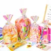 Envoltura de regalo 100 unids Bolsas de dulces Bolsa de almacenamiento de galletas de plástico láser transparente con lazos de giro dorado Favores de fiesta de cumpleaños de boda