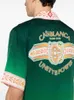 Nuevo producto Casablanca Diseñador Camisa casual de seda Hombres y mujeres Pareja Clásico Estampado de rayas Suelta Versátil Verano Hawaii Playa Camisa de seda Casablanc Tops