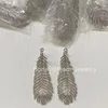 Boucle d'oreille en argent Plume de paon plumes de paon logo de créateur luxe bijoux fins diamant pavé chevalière anneaux de mariage pour couple créatif grand anneau