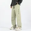 Calças masculinas primavera e outono cor sólida solta cintura alta elástica perna larga bolsos com zíper moda casual calças de rua