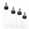 Bouteilles de stockage 50pcs 30ml / 60ml / 120ml E liquide PET compte-gouttes en plastique vide bouteille d'encre de tatouage forme de stylo avec bouchons torsadés