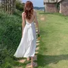 Robes décontractées 2024 Robe d'été pour femmes Mode sexy sangle suspendue dos ouvert noeud papillon blanc mi-longueur plage française rétro