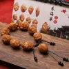 Strandprodukt Olivennuss handgeschnitztes Wanguan goldenes Krötenarmband Steinschnitzerei Sammeln Sie Vermögen