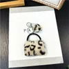 Keychains Lanyards Plush Leopard Pattern Wallet Keychain Womens Cartoon Coin Wallet with Keychain Mini Earphone Bag Decorative Gift J240330