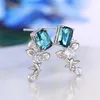 Boucles d'oreilles pendantes Huitan fleur esthétique pour femmes accessoires d'oreille de couleur argent de luxe avec zircon cubique bleu bijoux floraux romantiques