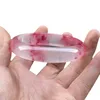 Glace à travers le bracelet en jade de quartzite flottant rouge pêche