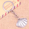 Keychains 20pcs mode Keychain 25 30 mm pendentifs coquilles diy hommes bijoux carle de chariot de chaîne de clé porte-anneau Souvenir pour cadeau