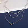 Pendentif Colliers Vintage multi-niveaux collier en forme de coeur pour femmes mode féminine argent-plaque cristal artificiel chaîne de perles bijoux