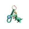 Söt dinosaurie nyckelring nyckelring par hänge tecknad ryggsäck dockdocka docka pendelldocka bil
