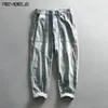 Pantalon masculin laver les jeans décontractés de l'eau de Javel entièrement enrôlé de denim en détresse vintage de cargaison de cargaison