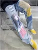 Pantalones de jeans de mosaicos Pantalones de agujero raspado Motorcillo gráfico Diseñador Slim Diseñador Casual Hip Hop Streetwear Punk Unisex Denim ropa de mezclilla