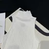 Dames T-shirtontwerper Early Spring Nieuwe Loe High Ding Koreaanse stijl Minimalistische nek Taille Wrap Solid Color Versatiele mouwloze gebreide tanktop 5DQ4