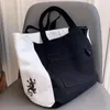 Sacs de soirée Japon Exportation unique de commerce extérieur AB Black and White deux côtés Simple de grande capacité Portable Canvas Shopping Sac fourre-tout