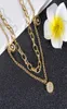 Luxe dubbel gelaagde 18K gouden ronde hang ketting witte zwarte schaal sieraden6469825