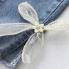 Broek 2023 Nieuwe 2-7y jeans meisjes elegante boog denim broek zoete boog elastiek elastiek schattige lente kinderbroeken baby pantsL2403