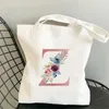 Caminhada minimalista de compras femininas Bolsa de lona rosa Letra de flor rosa ombro de grande capacidade para aluno Reutiliza Viagem Presente de viagem