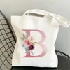 Caminhada minimalista de compras femininas Bolsa de lona rosa Letra de flor rosa ombro de grande capacidade para aluno Reutiliza Viagem Presente de viagem