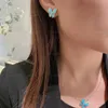 Collier de boucles d'oreilles Collier de papillon doré chaud et nouveau turquoise pour les femmes qui libère la température à la mode