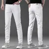 Mäns jeans designer europeisk ny vår/sommaren mäns jeans ren svartvit bomull hög elastiska små fötter smala fit koreanska enkla mäns byxor xooy