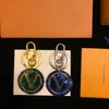 Keechain Designer Keychury Torketchain Luxury Donne uomini marrone borsetto in pelle grigliere oro accessori oro portachiavi con lettere top40