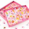 En gros de 100pcs pour enfants dessin animé bonbons fleuris d'animal forme de noix de nœud mix mix joail de bijoux anneaux