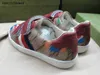 Nya baby sneakers tecknad mönster trycker barnskor storlek 26-35 Högkvalitativ varumärke förpackning spänne band flickor skor designer pojkar skor 24 maj