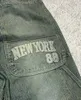 Męskie dżinsy amerykańskie wzór retro litera w wysokim poziomie dżinsy dla damskiej ulicy hip-hop guziki harajuku swobodne spodne