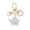 Tornari percorsi Creative retro White Angel keychain Womens Cute Mini Pearl a forma di cuore Auto Tortale Torching Bignetto Gioielli affascinanti J240509