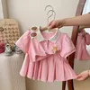 Set di abbigliamento ragazze preppy jk set per bambini estate di moda con stampa fumetto gonna pieghevole corean dolce simpatico manicotto corto a due pezzi a due pezzi