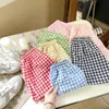 Shorts Korean style 2024 new childrens boys and girls shorts 2-7Y summer unisex anti mosquito childrens casual loose checkered shorts d240510