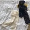 Femmes chaussettes en dentelle d'été accumule la mode mince lolita élastique dans le tube au-dessus de la robe de genou décoration mince bas de bas