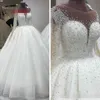 2022 Vestidos de noiva de cristal de contas luxuosos Princesa com ilusão de mangas compridas Tulle branco decote de decote oco com bola de costas 227g