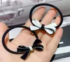 Fashion Black and White Acrylique Bow Rubber Band Hair Tie Clope Clope Coie épingles à cheveux populaires Bijoux de casseurs dans le pays européen et américain 3563176