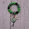 Bracelet imprimé de perle de perle en bois de perle de silicone à chaud de couleur chaude créative avec un bracelet pendentif et porte-clés et porte-clés en Europe et en Amérique personnalisés