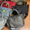 Designer -Tasche Leisure One Schulterkreuzkörper Handheld Knödel Tasche verdickte Nylon große Kapazität Mommy Bag Damenbeutel