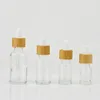 زجاجات التخزين 10pcs 5 مل-50 مل زجاجة زجاجة زجاجة زجاجية سميكة الحاوية التجميلية زيت ماصة من الخيزران مع غطاء الخيزران
