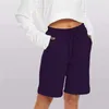 Short féminin Femmes décontractées entraînement de la course élastique pantalon de yoga athlétique poches sportives Pantalones de longueur de genou Cortos