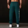 Jogger pour hommes pantalons de survêtement américain pour hommes de style gym de gym de fitness coton pantalon de coton imprimé pantalon de cordon de taille mid 240508