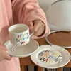 カップソーサー韓国の漫画の携帯電話カップお誕生日おめでとうセラミックブレックファーストカップケーキケーキプレートかわいいコーヒーカップとプレートセット