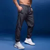 Pantalon masculin Bintuoshi Nouveau pantalon de sport pour hommes courir un pantalon avec des poches à fermeture éclair et un pantalon sportif joggings joggings fitness y240513