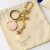 Keechchain di alta qualità classico squisito designer di lusso di lusso in lega unisex gold metal gollo gioielli piccoli