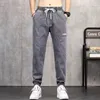 Jeans masculin 2024 Trache de taille élastique HARLAN CONCUT COST SERGET TIE DENIM JOGGER Streetwear Jean Pantalon