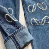 Designerin Frauen Jeans Ankunft High Wailstraße ausgehöhltes Patch Sticked Dekoration Casual Blue Straight Denim Hosen ausgehöhlt