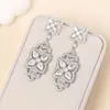 Dangle Earrings Evacandis Floral Design Inlaid Cubic Zirconia drop for Women Stylish White Golden Gemstoneプレミアムファインジュエリー