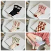 Chaussettes de style coréen Stripe Casual Letter Casual Knitting Middle Tube Coton Colon Color Couleur extérieure